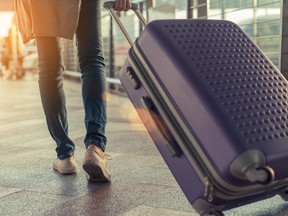 Traveler with suitcase in airport concept.Young girl  walking with carrying luggage and passenger for tour travel booking ticket flight at international vacation time in holiday rest and relaxation.