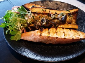 Escargot and Roasted Bone Marrow  - delicate garlic and white wine escargot gracing a beef bone marrow with grilled bread and shallots - Rita DeMontis photo