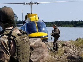 In this  July 29, 2019, file photo, RCMP search for Kam McLeod and Bryer Schmegelsky in Gillam, Man.