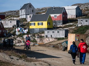 Residents walk in Kulusuk, Greenland on August 16, 2019. (JONATHAN NACKSTRAND/AFP/Getty Images)