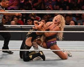 Charlotte Flair applies a submission hold on Toronto native Trish Stratus during their match at SummerSlam in Toronto on Sunday, Aug. 11, 2019. Flair defeated Stratus via submission in what Stratus called her final wrestling match.(Photo by Joseph Hrycych/For SLAM! Wrestling)