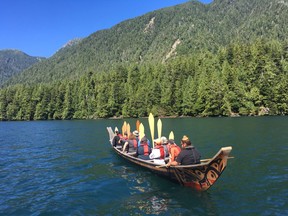 Paddles up as Ocean House guests man the oars for a trip around the area in a Haida carved red cedar canoe with cultural guides Jaylene Shelford singing and drumming at the front. (Jane Stevenson/Toronto Sun)