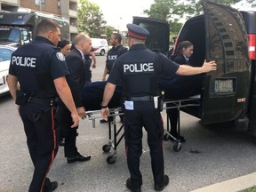 The body of a teenaged boy is removed from a Falstaff Ave. highrise after a fatal shooting Aug. 1, 2019. (Kevin Connor/Toronto Sun)