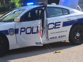 A yellow conducted energy device is seen attached to a Peel Regional Police cruiser on Idlewilde Cres. in Mississauga Aug. 13, 2019. Joe Warmington/Toronto Sun