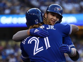 Blue Jays’ Bo Bichette (right) hugs teammate Vladimir Guerrero Jr., after opening last night’s game in Los Angeles with a home run against Dodgers ace Clayton Kershaw. It was his sixth homer of the season. (Getty Images)