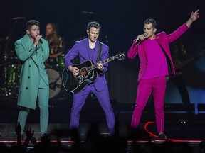 Nick Jonas, from left, Kevin Jonas, and Joe Jonas, of the Jonas Brothers, perform on stage during their "Happiness Begins" tour at the Capitol One Arena on Thursday, Aug. 15, 2019, in Washington. (Brent N. Clarke/Invision/AP)