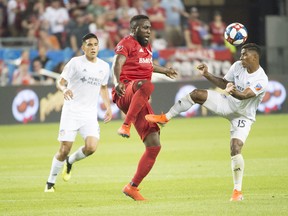 Toronto FC’s Jozy Altidore (centre) battles for a ball with FC Cincinnati’s Allan Cruz last weekend at BMO Field. Toronto faces 
the New York Red Bulls on Saturday night and should benefit from a healthy roster down the stretch. (USA TODAY SPORTS PHOTO)