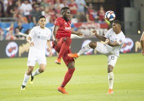 Toronto FC’s Jozy Altidore (centre) battles for a ball with FC Cincinnati’s Allan Cruz last weekend at BMO Field. Toronto faces 
the New York Red Bulls on Saturday night and should benefit from a healthy roster down the stretch. (USA TODAY SPORTS PHOTO)