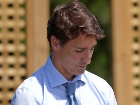 Prime Minister Justin Trudeau waits to be introduced before speaking  about a watchdog's report that he breached ethics rules by trying to influence a corporate legal case regarding SNC-Lavalin, in Niagara-on-the-Lake, Ont., Aug. 14, 2019.