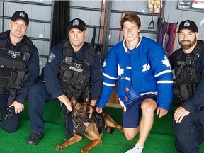 Mitch Marner of the Toronto Maple Leafs with members of the Durham Regional Police K9 unit.