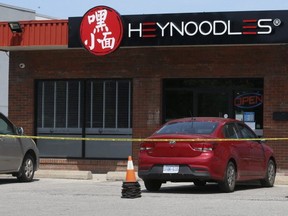 The outside of Hey Noodles restaurant at Hwy. 7 at Conservation Ave. in Markham was cordoned off with police tape on Friday, Aug. 2, 2019 -- a day after a man was killed and a woman was critically injured in a drive-by shooting. (Jack Boland/Toronto Sun/Postmedia Network)