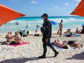 Mexican federal police patrol a beach.