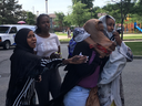 Grieving woman comfort one another on Thursday, Aug. 1, 2019, at a TCHC highrise on Falstaff Ave. where a boy, 16, was gunned down. (Kevin Connor/Toronto Sun/Postmedia Network)