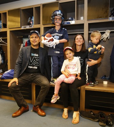 Darius Raso, a seven-year-old boy from Kleinburg, Ont. who has been battling acute lymphocytic leukemia for the past year, signed a one-day contract with the Toronto Argonauts and stands in his locker with (L-R) Marc (dad), Alyssia, 4 (sister), Cassandra (mom) and little brother Marcas, 2, on Thursday, Aug. 29, 2019. (Jack Boland/Toronto Sun/Postmedia Network)