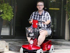 Justin Webb, whose scooter was recently stolen, takes a spin on his new ride, which was donated and delivered to him by Larry Kendall in Burlington on Wednesday, August 7, 2019. (Veronica Henri/Toronto Sun/Postmedia Network)
