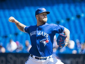 Blue Jays starting pitcher Sean Reid-Foley works against the Texas Rangers on Wednesday 
in Toronto. Reid-Foley lasted just 3.1 innings and took the loss. (THE CANADIAN PRESS)