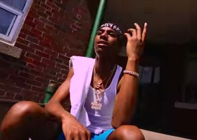 Toronto rapper Jahvante “Smoke Dawg” Smart, 21, who was gunned down in the city’s Entertainment District on June 30, 2018, wears a Halal Gang pendant hanging from a gold chain in his video Fountain Freestyle while sitting out front of a Gerrard St. E. apartment building in Regent park. (YouTube)
