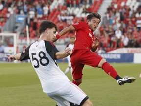 TFC’s Justin Morrow (left) battles for the ball with Ottawa Fury’s Christiano Francois in the first half of a Canadian Championship semifinal at BMO Field last night.  Dan Hamilton/USA TODAY Sports