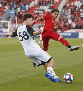 TFC’s Justin Morrow (left) battles for the ball with Ottawa Fury’s Christiano Francois in the first half of a Canadian Championship semifinal at BMO Field last night.  Dan Hamilton/USA TODAY Sports