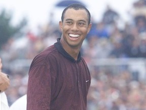 Tiger Woods, after tossing away his cap, breaks out into a huge grin upon capturing the 2000 Canadian Open on the final hole at Glen Abbey. (Postmedia Network files)