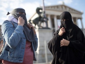 Women wear a traditional hijab headdress protest against Austria's ban on full-face Islamic veils in Vienna, Austria, on Oct. 1, 2017.