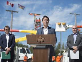 Minister of Fisheries, Oceans and the Canadian Coast Guard, Jonathan Wilkinson, left, and British Columbia Premier John Horgan, right, look on as Prime Minister Justin Trudeau makes an announcement at BC Hydro Trades Training Centre in Surrey, B.C., Thursday, August, 29, 2019. THE CANADIAN PRESS/Jonathan Hayward