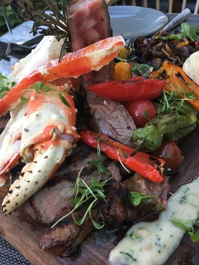 Alaskan crab and jumbo prawns cascade over an exquisitely grilled USDA Prime porterhouse at The Victor in Parq resort. (Kevin Hann)