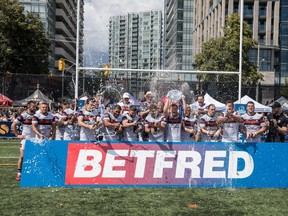 Toronto Wolfpack captain Josh McCrone lifts the Betfred Championship Shield with his teammates at Lamport Stadium yesterday. It was the first home game for the club since clinching the league title on July 21 in Widnes, England. (Mathew Tsang photo)