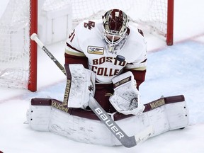 Boston College goaltender Joseph Woll (31) makes a save on a shot by Harvard forward Michael Floodstrand (44) in the third period during the first round of the Beanpot NCAA college hockey tournament in Boston, Monday, Feb. 4, 2019. Boston College defeated Harvard 2-1. (AP Photo/Charles Krupa)