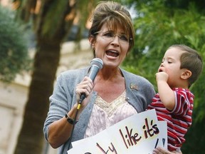 Politician and conservative activist Sarah Palin holds her son Trig Palin as she speaks during a rally for the Tea Party Express national tour in Phoenix, Ariz., Oct. 22, 2010,