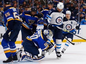 Jordan Binnington of the St. Louis Blues makes a save as Dustin Byfuglien of the Winnipeg Jets runs into him in Game Three of the Western Conference First Round during the 2019 NHL Stanley Cup Playoffs at the Enterprise Center on April 14, 2019 in St. Louis, Missouri.
