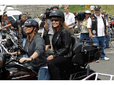 May 29, 2011: Former U.S. Vice presidential candidate and Alaska Governor Sarah Palin rides on the back of a motorcycle before participating in "Rolling Thunder" rally in Arlington, Va.