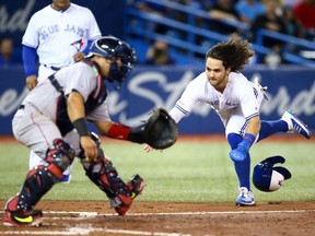 Bo Bichette of the Toronto Blue Jays scores a run on a triple by Cavan Biggio #8 in the fifth inning during a MLB game against the Boston Red Sox at Rogers Centre on September 12, 2019 in Toronto, Canada.