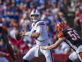 Josh Allen #17 of the Buffalo Bills pulls up to pass the ball just before a hit by Nick Vigil #59 of the Cincinnati Bengals during the fourth quarter at New Era Field on September 22, 2019 in Orchard Park, New York. Buffalo defeats Cincinnati 21-17.  (Brett Carlsen/Getty Images)