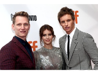 Tom Harper, left, Felicity Jones, centre, and Eddie Redmayne attend "The Aeronauts" premiere during the Toronto International Film Festival at Roy Thomson Hall on Sept. 8, 2019 in Toronto.