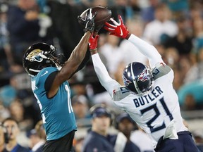 Dede Westbrook #12 of the Jacksonville Jaguars makes a catch against Malcolm Butler of the Tennessee Titans during the first quarter of a game at TIAA Bank Field on September 19, 2019 in Jacksonville, Florida.