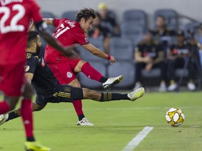 Toronto FC midfielder Tsubasa Endoh scores against Los Angeles FC while defended by Steven Beitashour on Saturday night in Los Angeles. TFC drew with LAFC 1-1. 
Kelvin Kuo/USA TODAY