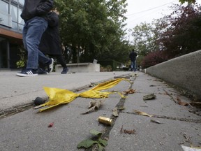 A shell casing is discovered on the sidewalk by the Toronto Sun a day after a young woman was critically injured by 2 bullets at the Wellington St. location. (Stan Behal)