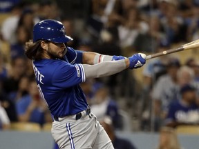 Blue Jays rookie Bo Bichette hits a solo home run against the Los Angeles Dodgers during a game in mid-August. (Marcio Jose Sanchez/The Associated Press)