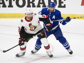 Maple Leafs’ John Tavares tangles with defenceman Nick Ebert of the Senators last night in St. John’s.    Joe Chase/The Canadian Press