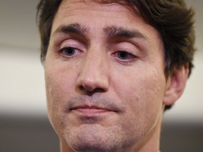 Liberal Leader Justin Trudeau reacts as he makes a statement in regards to photo coming to light of himself from 2001 wearing "brownface" during a scrum on his campaign plane in Halifax, N.S., on Wednesday, September 18, 2019. THE CANADIAN PRESS/Sean Kilpatrick