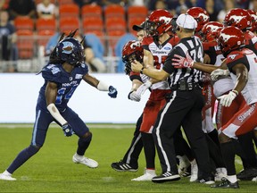 Toronto Argonauts defensive back Abdul Kanneh gets into an argument with members of the Calgary Stampeders during second half of CFL action in Toronto, Friday, Sept. 20, 2019. THE CANADIAN PRESS/Cole Burston