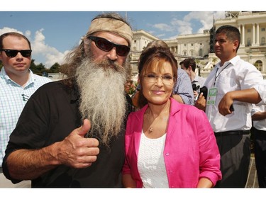 Sept. 9, 2015: Reality television personality Phil Robertson and Sarah Palin pose for photographs during a rally against the Iran nuclear deal on the West Lawn of the U.S. Capitol in Washington, D.C.