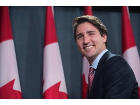 Canadian Liberal Party leader Justin Trudeau smiles at the end of a press conference in Ottawa on October 20, 2015 after winning the general elections.