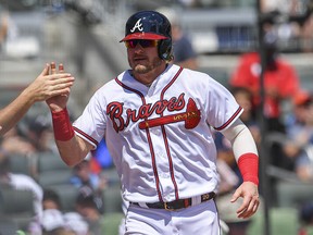 Atlanta Braves third baseman Josh Donaldson (20) gets a high five after scoring a run against the Toronto Blue Jays during the third inning at SunTrust Park. (Dale Zanine-USA TODAY Sports)