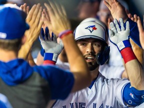 Toronto Blue Jays outfielder Randal Grichuk (15) celebrates with teammates in the dugout after hitting a home run against the Baltimore Orioles during the first inning at Rogers Centre. Kevin Sousa-USA TODAY