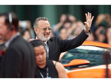 Actor Tom Hanks waves to fans as he arrives for the premiere of "A Beautiful Day in the Neighborhood" during the 2019 Toronto International Film Festival Day 3 on Sept. 7, 2019 in Toronto.