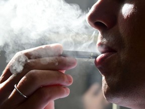 This file photo taken on October 02, 2018 shows a man exhaling smoke from an electronic cigarette in Washington, DC.