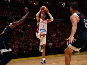 Canada's Andrew Nembhard, centre, shoots a basket during their friendly basketball match in Sydney on Aug. 26, 2019, ahead of the World Basketball Championships in China starting on August 31. (SAEED KHAN/AFP/Getty Images)