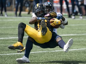Hamilton Tiger-Cats wide receiver Brandon Banks (16) is tackled by Toronto Argonauts defensive back Trumaine Washington (36) in Hamilton on Monday, Sept. 2, 2019. (THE CANADIAN PRESS/Peter Power)